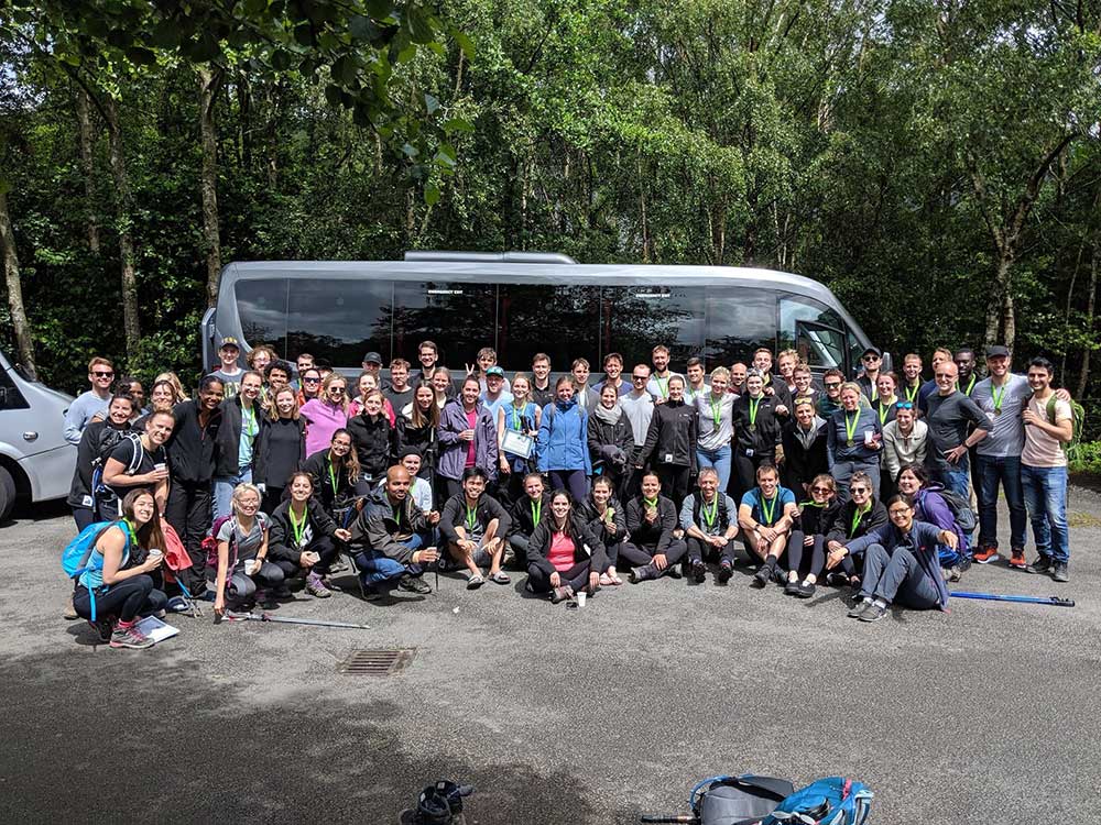 Fundraising participants celebrating with their medals after a Three Peaks event